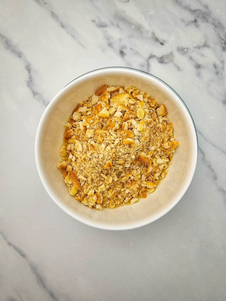 Crushed Ritz crackers in a small bowl for the potato casserole topping.